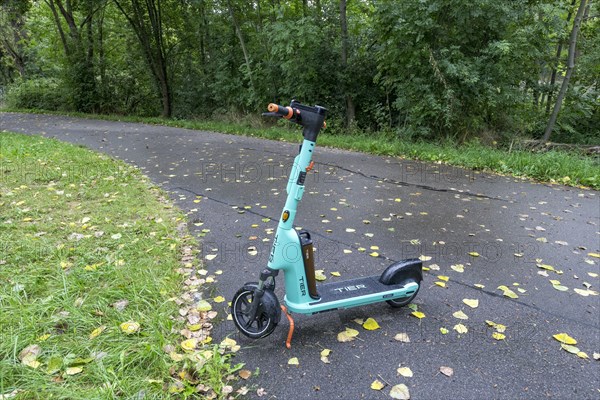 E-scooter of bike rental company TIER parked on pavement