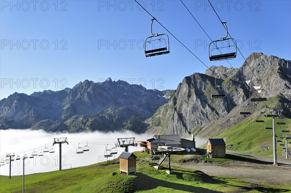 Empty chairlift in the mist at sunrise along the Col du Tourmalet in the Pyrenees