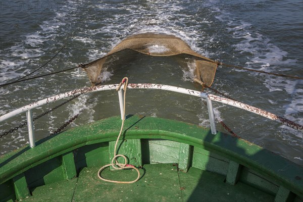 Shrimp boat with fish net fishing for shrimps on the North Sea