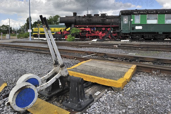 Steam train and track switch levers at the depot of the Chemin de Fer a Vapeur des Trois Vallees at Mariembourg