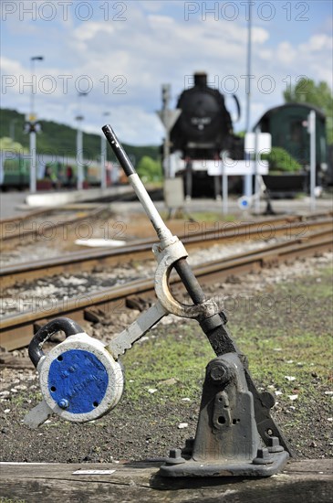 Steam train and track switch levers at the depot of the Chemin de Fer a Vapeur des Trois Vallees at Mariembourg