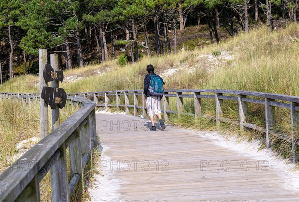 Man walking on wooden boardwalk