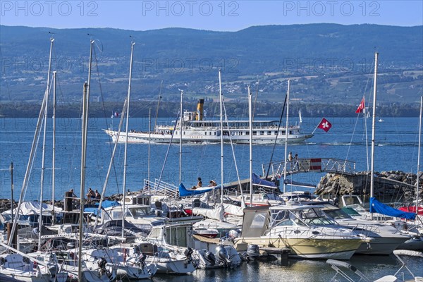 Swiss historic Belle Epoque paddle steamboat Savoie and sailing boats in the marina at Yvoire along Lake Geneva