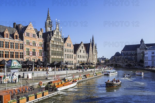 Sightseeing boats with tourists on the river Lys with view over guildhalls at the Graslei