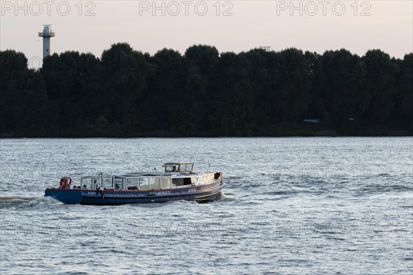 The barge Nordsee IV on a harbour cruise in the evening light on the Elbe in the port of Hamburg
