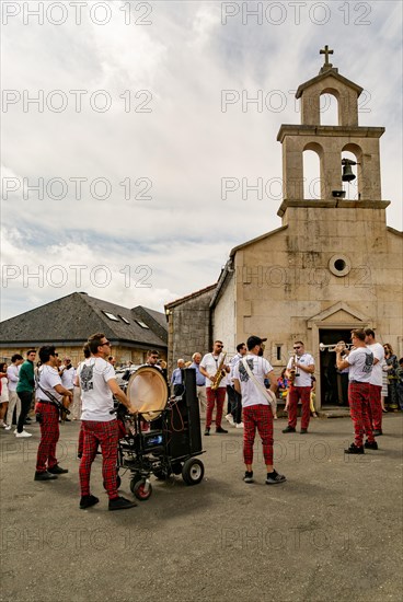 Village fiesta musicians and villagers outside chapel church