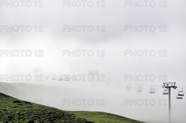 Chairlift in the mist at sunrise along the Col du Tourmalet in the Pyrenees