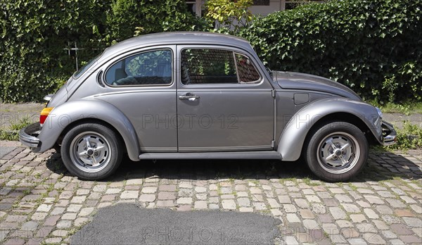 Silver VW Beetle parked on the street