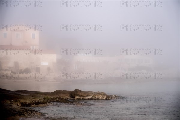 Coastal village in the morning mist