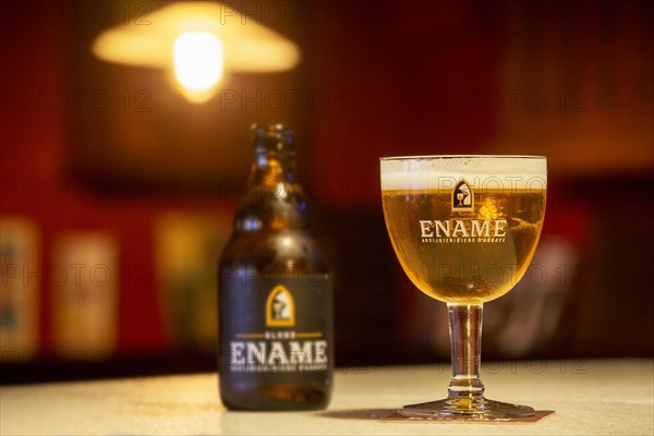 Ename blond beer glass and beer bottle