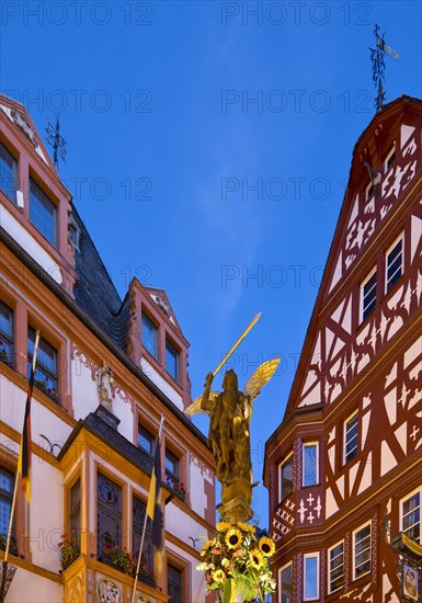 St. Michael's Fountain with town hall and gabled half-timbered house in the evening