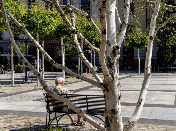 Senior sitting on a bench in the former parcel yard