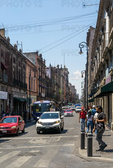 Traffic in city centre street with historic buildings