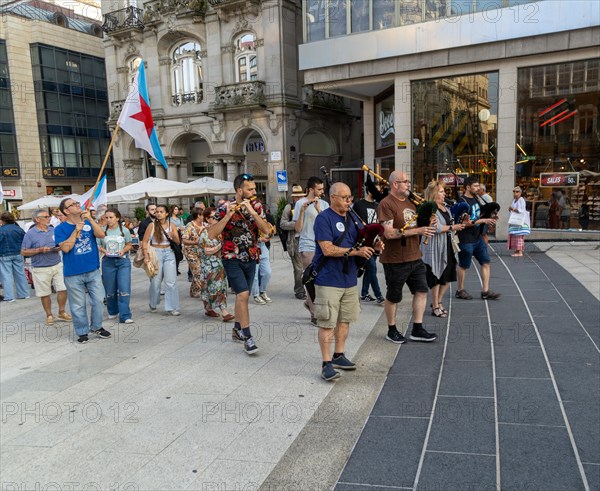 Bagpipe playing musicians BNG political party election campaign in plaza Praza Porto do Sol