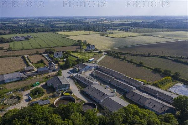 Aerial view of pig farm with closed stables and manure reservoirs