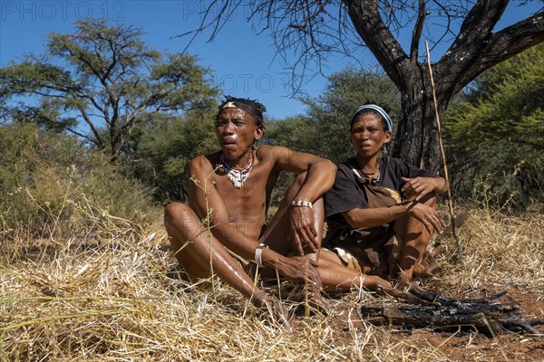 Bushman and San woman making fire in Kalahari