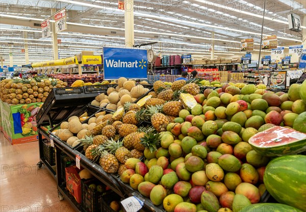 Goods and produce on display inside Walmart superstore shop store