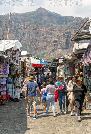 People walking past stalls in the market