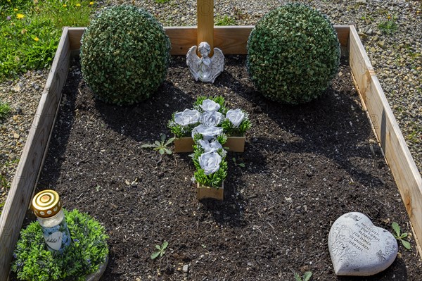 Simple grave with praying angel