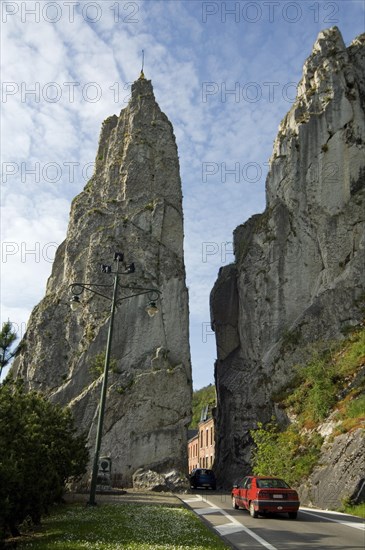 Car driving past the rock formation Rocher Bayard at Dinant along the river Meuse