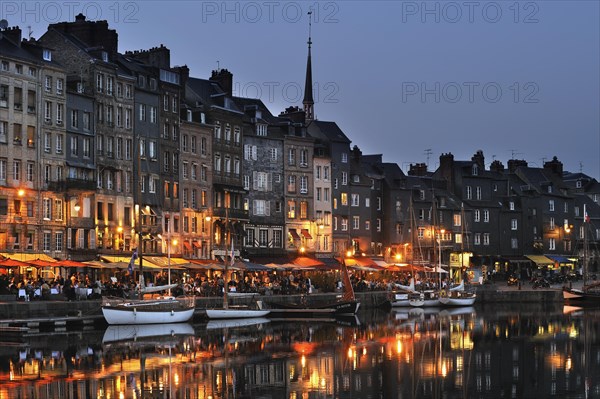 Sailing boats and tourists at pavement cafes