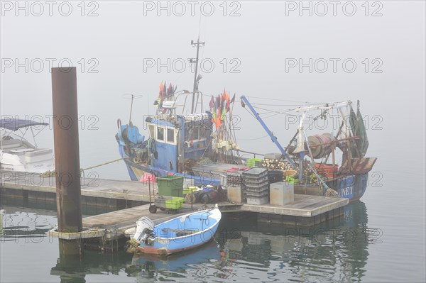 Fishing boat in thick fog in the harbour at Saint-Denis-d'Oleron on the island Ile d'Oleron