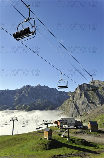 Empty chairlift in the mist at sunrise along the Col du Tourmalet in the Pyrenees