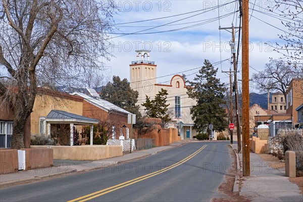 Street with houses in adobe Pueblo Revival style in the suburbs of Santa Fe