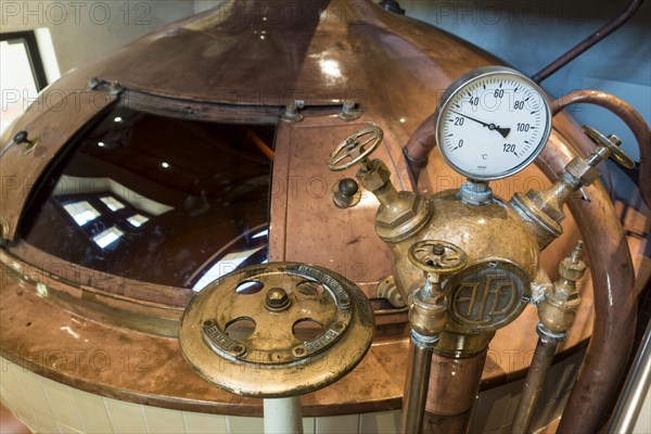 Gauge and valves on copper kettle of Trappist beer brewery in the Orval Abbey