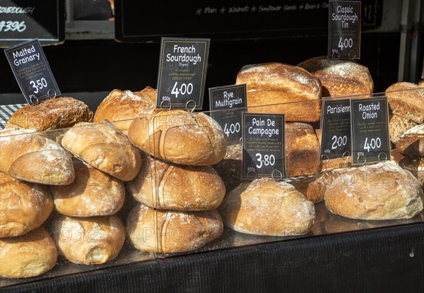 Fresh loaves of artisan bread on sale at street market stall