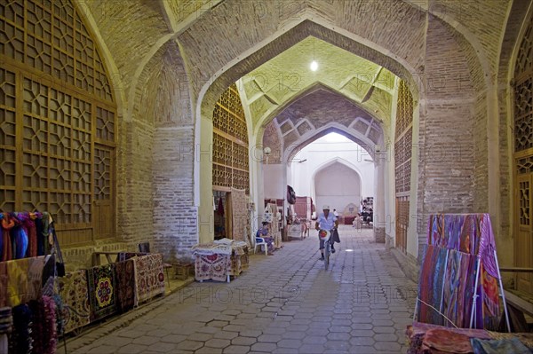 Carpets for sale in the old indoor market of the historic Silk Road town Bukhara