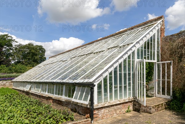 Greenhouse inside the walled kitchen garden Redisham Hall gardens and plant nursery