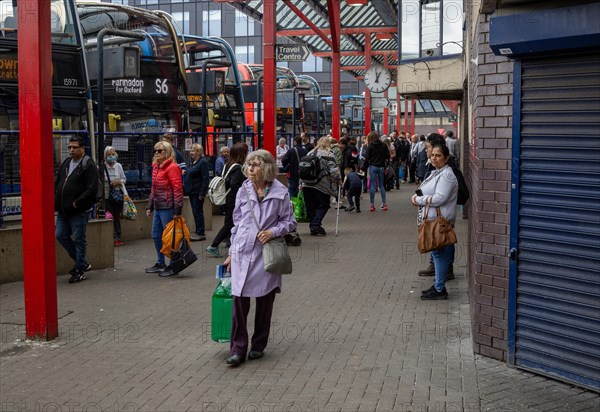 People and buses in bus station in the town centre