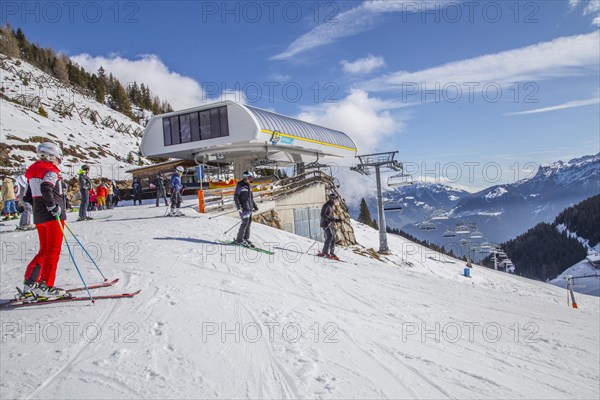 Skiers start at the top station of the Tappenalm cable car on the piste