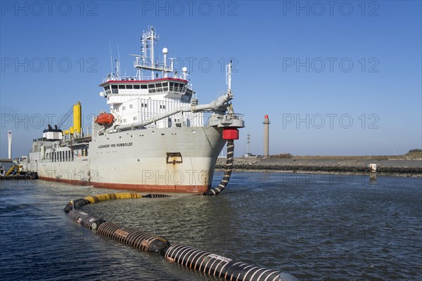 Trailing suction hopper dredger Alexander von Humboldt in port of Ostend discharging sand via long hoses