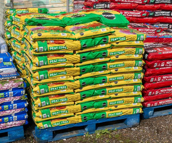 Bags of MiracleGro peat free compost on sale in garden centre