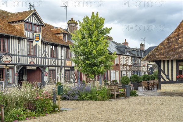 Half-timbered houses and cafes in one of the most beautiful villages in France Beuvron-en-Auge