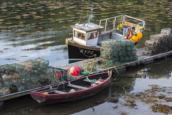 Moored small fishing boat and lobster pots