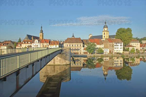 View from the historic Alte Mainbruecke on townscape with St. Johannes church and protestant town church bridge pier