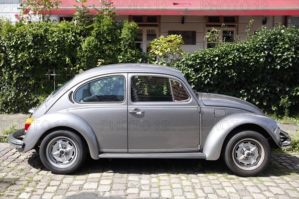 Silver VW Beetle parked on the street