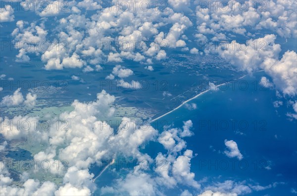 Oblique angle aerial view through plane window over Caribbean coast