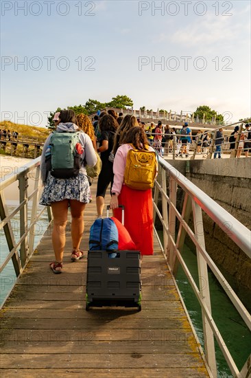 Passengers arriving at ferry terminal pier