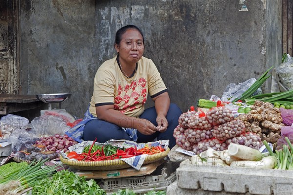 Indonesian vendor selling greens at vegetable market in Jakarta