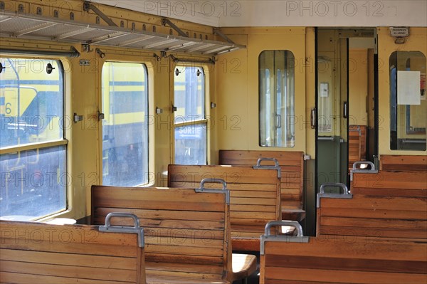 Old passenger carriage with wooden benches at the depot of the Chemin de Fer a Vapeur des Trois Vallees at Mariembourg