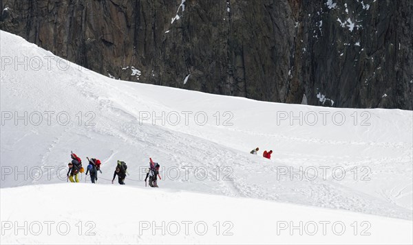 Ski mountaineers ascending snow slope of the Mont Blanc in the French Alps