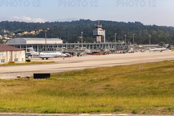 View through plane window of airport terminal buildings at Vigo