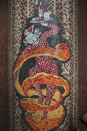 Mosaic motif of a waiter on a column in front of a bistro