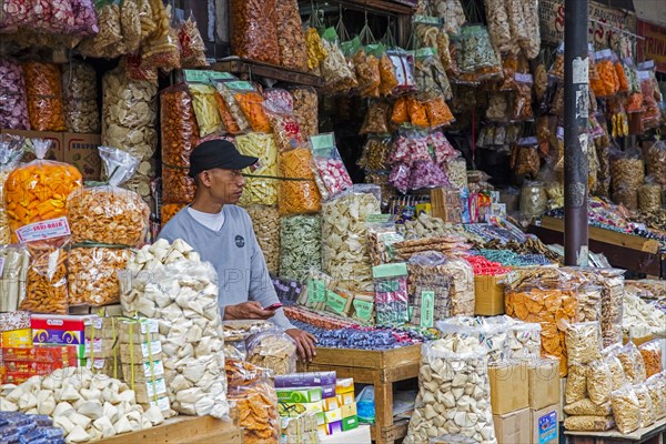 Javanese street vendor selling deep fried crackers called krupuk