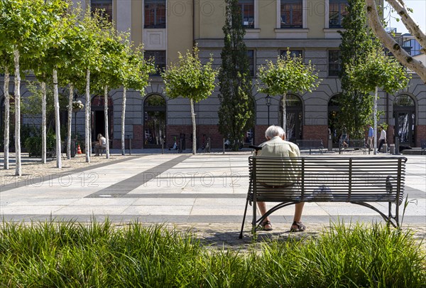 Senior sitting on a bench in the former parcel yard