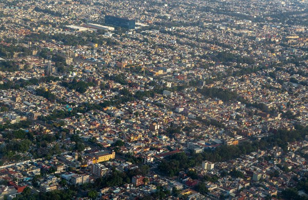 Oblique angle aerial view through plane window over Mexico City